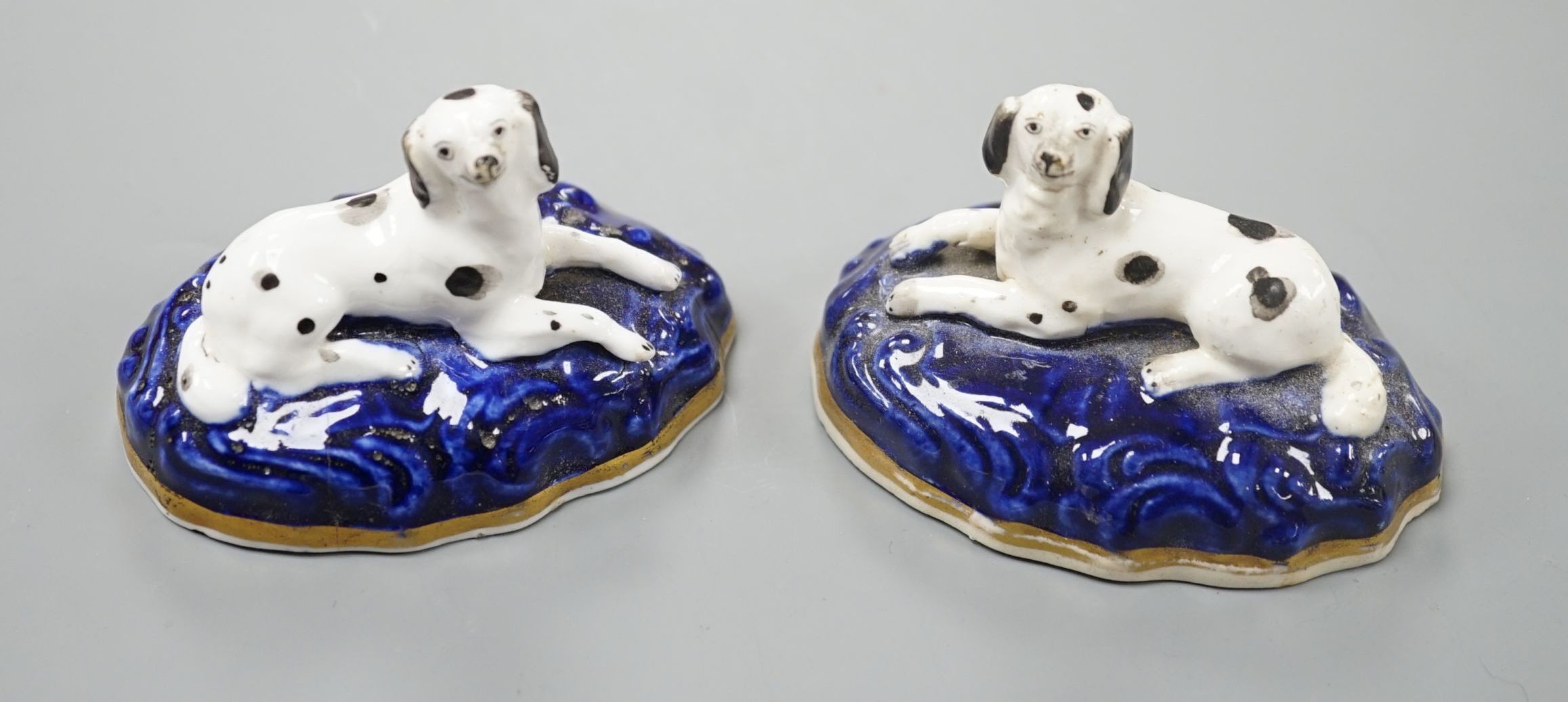 A pair of Samuel Alcock porcelain models of recumbent king Charles spaniels, c.1835-40, impressed mark 18, 7.3 cm long , Cf. Dennis G.Rice Dogs in English porcelain, colour plate 136 and 137., Provenance: Dennis G.Rice c